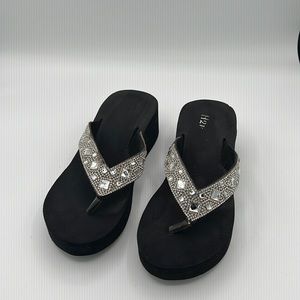 Black and silver wedge flip flop sandal. Good condition